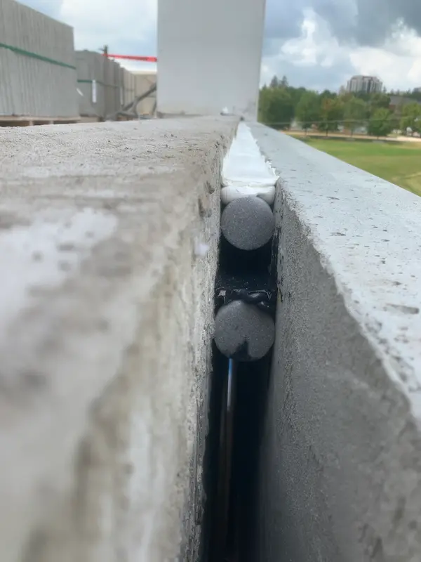 Worker caulking a window