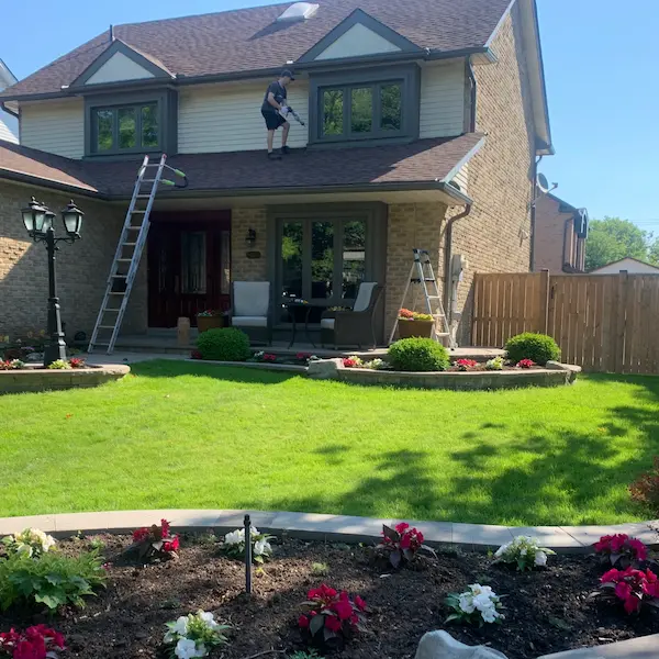 Worker caulking a window